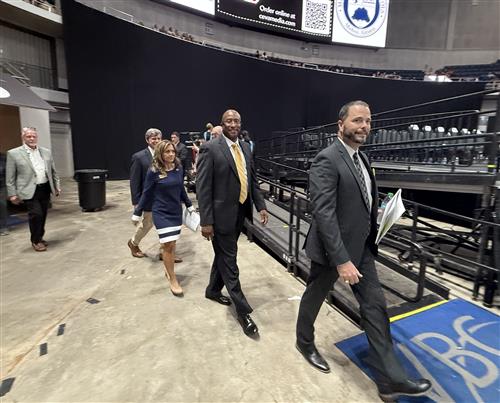 board members entering stage to graduation
